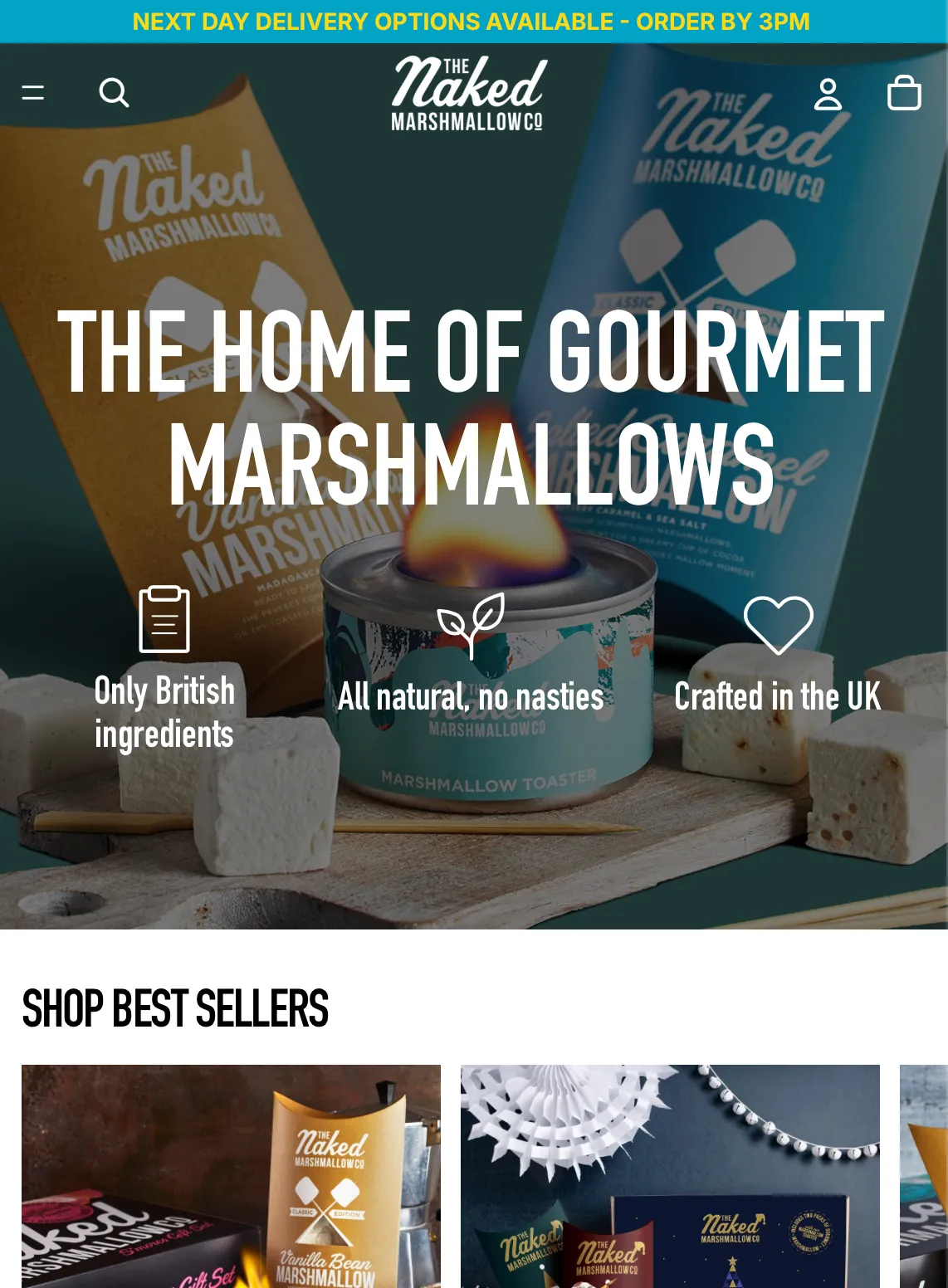 The Naked Marshmallow Co homepage on a phone: a next-day delivery announcement bar, a hero reading The Home of Gourmet Marshmallows over product photography with a lit marshmallow toaster, three value props (Only British ingredients, All natural no nasties, Crafted in the UK), and a Shop Best Sellers carousel.